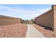 Private walkway leading to a gated community entrance, showcasing the neighborhood's security at 8668 Hartmont St, Las Vegas, NV 89166