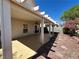 Spacious covered back patio with desert landscaping and access to the home at 8872 Perfect Diamond Ct, Las Vegas, NV 89129