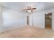 Bedroom featuring neutral carpet and a ceiling fan, with a walk-in closet visible at 8872 Perfect Diamond Ct, Las Vegas, NV 89129