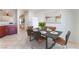 Open dining room features a dining table set for six, an art wall, and easy kitchen access at 8872 Perfect Diamond Ct, Las Vegas, NV 89129