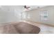 Spacious living room with large windows, lots of natural light, and stairwell access at 8872 Perfect Diamond Ct, Las Vegas, NV 89129
