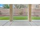 Backyard patio featuring artificial grass and a brick wall border, creating a cozy outdoor setting at 9010 Wine Cellar Ave, Las Vegas, NV 89148
