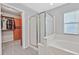 This bathroom features a glass-enclosed shower, soaking tub and access to a walk-in closet at 9010 Wine Cellar Ave, Las Vegas, NV 89148
