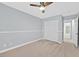 Comfortable bedroom with soft carpet, ceiling fan, and a spacious closet at 9010 Wine Cellar Ave, Las Vegas, NV 89148