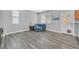 Comfortable living area with modern wood-look flooring and seamless access to the kitchen at 9010 Wine Cellar Ave, Las Vegas, NV 89148