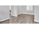 Spacious living area with durable wood-look flooring, neutral gray walls, and plenty of natural light at 9010 Wine Cellar Ave, Las Vegas, NV 89148
