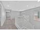 Neutral toned loft with white railings, large windows and several entryways at 9010 Wine Cellar Ave, Las Vegas, NV 89148