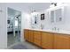 Bathroom with double sinks, framed mirrors, stylish vanity, and a view to the bedroom at 9112 Vista Greens Way # 204, Las Vegas, NV 89134