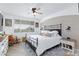 Bright bedroom featuring a ceiling fan, large window, and a comfortable bed with stylish pillows at 9112 Vista Greens Way # 204, Las Vegas, NV 89134