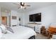 Cozy bedroom with white walls, ceiling fan, television and a comfortable bed with soft pillows at 9112 Vista Greens Way # 204, Las Vegas, NV 89134