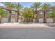 Exterior view of homes with garages, well-maintained landscaping, and palm trees at 9112 Vista Greens Way # 204, Las Vegas, NV 89134