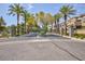 Community entrance featuring well manicured landscaping, towering palm trees, and attractive stone-clad posts at 9112 Vista Greens Way # 204, Las Vegas, NV 89134