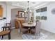 The dining area features a modern chandelier, neutral tones, and outdoor views for a cozy atmosphere at 9112 Vista Greens Way # 204, Las Vegas, NV 89134