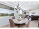 The dining area is filled with natural light, offering serene views of the outdoors at 9112 Vista Greens Way # 204, Las Vegas, NV 89134