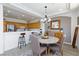 A beautiful dining area boasts a modern chandelier and a stylish wooden sideboard at 9112 Vista Greens Way # 204, Las Vegas, NV 89134