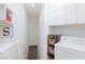 Well-organized laundry room with white cabinets and modern appliances at 9112 Vista Greens Way # 204, Las Vegas, NV 89134