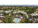 Aerial view of luxury townhomes with a pool and manicured landscaping near a golf course at 9112 Vista Greens Way # 204, Las Vegas, NV 89134