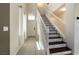 Bright entryway featuring tile flooring, a staircase, and a view of the front door at 9712 Red Horse St, Las Vegas, NV 89143