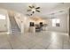 Open concept living room and kitchen with tile flooring and staircase to the left at 9712 Red Horse St, Las Vegas, NV 89143