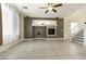 Bright living room with neutral tile flooring, fireplace, and staircase to the right at 9712 Red Horse St, Las Vegas, NV 89143