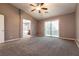 Carpeted main bedroom with a ceiling fan and sliding glass doors to the outdoor patio at 9712 Red Horse St, Las Vegas, NV 89143