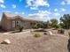 Expansive backyard landscaped with drought-tolerant plants and stone accents surround the property at 10417 Sea Palms Ave, Las Vegas, NV 89134
