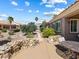 Well maintained backyard with lush landscaping, rock features, and an outdoor seating area at 10417 Sea Palms Ave, Las Vegas, NV 89134