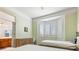 Bright bedroom with natural light featuring two beds, a bay window, and an ensuite bathroom at 10417 Sea Palms Ave, Las Vegas, NV 89134