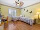 Bright bedroom featuring hardwood flooring, a ceiling fan, and lots of natural light at 10417 Sea Palms Ave, Las Vegas, NV 89134