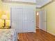 Cozy bedroom features wood floors, closet with sliding doors, and stylish furnishings at 10417 Sea Palms Ave, Las Vegas, NV 89134