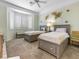 Cozy bedroom featuring carpet flooring, a bay window, and ample natural light at 10417 Sea Palms Ave, Las Vegas, NV 89134