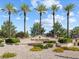 Welcoming entrance to Sun City Summerlin with palm trees and well-maintained landscaping at 10417 Sea Palms Ave, Las Vegas, NV 89134