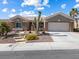Charming single-story home showcasing desert landscaping and a two-car garage at 10417 Sea Palms Ave, Las Vegas, NV 89134