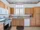 Bright kitchen equipped with granite countertops, wooden cabinets, a window, and stainless-steel appliances at 10417 Sea Palms Ave, Las Vegas, NV 89134