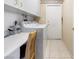 Functional laundry room featuring lots of counter space, lots of cabinets, and a washer-dryer at 10417 Sea Palms Ave, Las Vegas, NV 89134