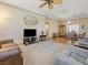 Spacious living room featuring carpeted floors, ceiling fan and television at 10417 Sea Palms Ave, Las Vegas, NV 89134