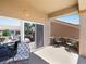 Comfortable covered patio features neutral tones, stone accents and access to the backyard at 10417 Sea Palms Ave, Las Vegas, NV 89134
