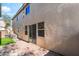 Backyard showing pavers and grassy area with wall along property line and string lights at 10917 Mount Pendleton St, Las Vegas, NV 89179