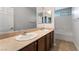 Well-lit bathroom boasts double sinks, a large mirror, and a shower-tub combo at 10917 Mount Pendleton St, Las Vegas, NV 89179
