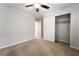 Bedroom with neutral paint, plush carpet, ceiling fan, closet, and an open doorway at 10917 Mount Pendleton St, Las Vegas, NV 89179