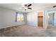 Spacious bedroom with soft carpet, large window and view of an open closet at 10917 Mount Pendleton St, Las Vegas, NV 89179