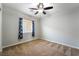Bedroom showcasing window with curtains, neutral paint, plush carpet, and a ceiling fan at 10917 Mount Pendleton St, Las Vegas, NV 89179