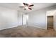 Neutral bedroom featuring a ceiling fan, and two doors, carpeted flooring, and a closet at 10917 Mount Pendleton St, Las Vegas, NV 89179