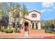 Charming two-story home featuring a red door, desert landscaping and a welcoming brick facade at 10917 Mount Pendleton St, Las Vegas, NV 89179