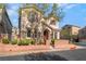 Inviting two-story home featuring a red door, stone accents, and a well-maintained landscape at 10917 Mount Pendleton St, Las Vegas, NV 89179