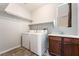 Functional laundry area equipped with a sink, washer, dryer, storage, and a window at 10917 Mount Pendleton St, Las Vegas, NV 89179