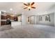 Open concept living area with gray carpet, recessed lights, and kitchen with dark wood cabinets at 10917 Mount Pendleton St, Las Vegas, NV 89179