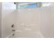 Bright white shower-tub combo showcasing a built-in shower niche and an above window at 10917 Mount Pendleton St, Las Vegas, NV 89179