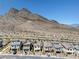 Panoramic aerial view of a neighborhood nestled against majestic mountains at 11652 Desert Hollow Ave, Las Vegas, NV 89138