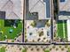 Aerial view of backyard featuring green grass and stone and patio with seating at 11652 Desert Hollow Ave, Las Vegas, NV 89138